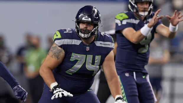 Seattle Seahawks' Jake Curhan on the line of scrimmage as the ball is snapped to quarterback Sean Mannion against the Denver Broncos during the second half of an NFL football preseason game, Saturday, Aug. 21, 2021, in Seattle. The Broncos won 30-3.